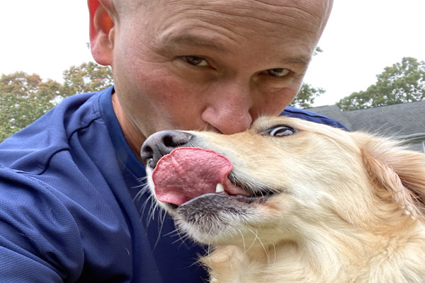 man kissing a dog